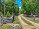 Gated entrance and long driveway leading to the property and through mature trees at 35657 Ashley Ln, Dade City, FL 33523