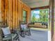 Cozy porch with rocking chairs and a porch swing overlooking a tranquil green landscape at 35657 Ashley Ln, Dade City, FL 33523