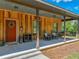 Inviting front porch with a red door, rocking chairs, and a porch swing at 35657 Ashley Ln, Dade City, FL 33523