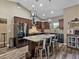 Open kitchen with stainless appliances, granite countertops and island with seating, under modern lighting at 35657 Ashley Ln, Dade City, FL 33523