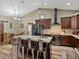 Modern kitchen featuring a large island with seating, and stainless steel appliances and fixtures at 35657 Ashley Ln, Dade City, FL 33523
