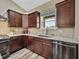 Beautiful kitchen featuring granite countertops, stainless steel appliances, and dark wood cabinetry at 35657 Ashley Ln, Dade City, FL 33523