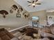 Inviting living room featuring a vaulted ceiling, wood floors, and views of the entryway door at 35657 Ashley Ln, Dade City, FL 33523