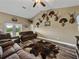 Comfortable living room featuring vaulted ceilings and wood floors that add warmth and style at 35657 Ashley Ln, Dade City, FL 33523