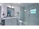 Modern bathroom with a glass-enclosed shower, updated fixtures, and a vanity with marble countertop at 3605 W Anderson Ave, Tampa, FL 33611
