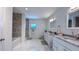 Modern bathroom with double sinks, marble countertops, and glass shower at 3605 W Anderson Ave, Tampa, FL 33611