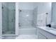 Modern bathroom featuring a glass shower, soaking tub, and white marble tile at 3605 W Anderson Ave, Tampa, FL 33611
