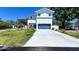 Modern two-story home featuring a gray garage door, fresh landscaping, and a long driveway at 3605 W Anderson Ave, Tampa, FL 33611