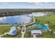 Scenic aerial view showcasing a park featuring a large lake, playground, splash pad, and lush greenery at 4106 Queller Way, Tampa, FL 33618