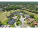 Panoramic aerial view showcasing homes nestled within a lush, green landscape with a picturesque golf course and serene lake at 4106 Queller Way, Tampa, FL 33618