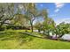 Expansive backyard features mature trees, lush lawn, and landscaping, offering a serene and private outdoor space at 4106 Queller Way, Tampa, FL 33618