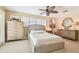 Neutral bedroom with carpet, ceiling fan, shuttered windows, and stylish furnishings at 4106 Queller Way, Tampa, FL 33618