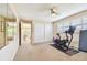 Bright bedroom featuring ceiling fan, plantation shutters, and large mirrored closet for storage at 4106 Queller Way, Tampa, FL 33618