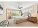 Bedroom featuring a bed, ceiling fan, windows with shutters, and a chair at 4106 Queller Way, Tampa, FL 33618