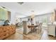 Elegant dining room featuring a large mirror, modern lighting, and seating for six at 4106 Queller Way, Tampa, FL 33618
