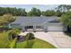 Beautiful single-story home boasts lush landscaping, a brick driveway, and a spacious two-car garage at 4106 Queller Way, Tampa, FL 33618