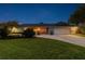 Charming home exterior at twilight with well-manicured lawn, landscaped garden, and paved driveway at 4106 Queller Way, Tampa, FL 33618