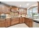 Well-equipped kitchen with stainless steel appliances, granite countertops, custom cabinets, and mosaic backsplash at 4106 Queller Way, Tampa, FL 33618