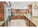 Gourmet kitchen with stainless steel appliances, granite countertops, custom cabinets, and mosaic backsplash at 4106 Queller Way, Tampa, FL 33618