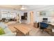 Spacious living room featuring mirrored closet, ceiling fan, and comfortable office area with desk at 4106 Queller Way, Tampa, FL 33618