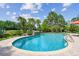 Backyard pool featuring tropical landscaping, brick pavers, and a waterfall feature for relaxation at 4106 Queller Way, Tampa, FL 33618