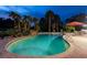 Backyard pool featuring tropical landscaping, brick pavers, and a waterfall feature for relaxation at 4106 Queller Way, Tampa, FL 33618