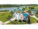 Aerial view of a modern splash pad with colorful features, surrounded by green spaces and shaded seating areas at 4106 Queller Way, Tampa, FL 33618