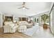 Bright sunroom featuring tile flooring, ceiling fan, and sliding glass doors providing ample natural light at 4106 Queller Way, Tampa, FL 33618