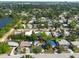 An aerial view of a residential neighborhood with tree-lined streets and a lake in the distance at 4111 W Marietta St, Tampa, FL 33616