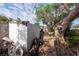 Side view of fire-damaged home and debris in the backyard at 4111 W Marietta St, Tampa, FL 33616