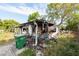 View of a fire-damaged home and yard debris at 4111 W Marietta St, Tampa, FL 33616