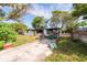 View of a fire-damaged home with a neglected front yard at 4111 W Marietta St, Tampa, FL 33616