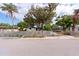 View of the property from the street, featuring an overgrown front yard and a distressed house at 4111 W Marietta St, Tampa, FL 33616