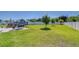 Spacious backyard featuring a well-maintained lawn, trees, a shed, and a white fence at 4444 Devinshire Fields Loop, Plant City, FL 33567