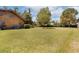 Expansive backyard with lush green grass and mature trees, perfect for outdoor activities at 4801 Lynn Oaks Cir, Dover, FL 33527