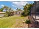 Green backyard featuring a shed, landscaping, and a peek at the screened-in pool area at 4801 Lynn Oaks Cir, Dover, FL 33527