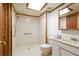 Bright bathroom featuring a walk-in shower, grab bar, and vanity with ample storage at 4801 Lynn Oaks Cir, Dover, FL 33527