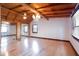 Spacious bedroom featuring wood floors, exposed wood beam ceiling, chandelier, and a double mirrored closet at 4801 Lynn Oaks Cir, Dover, FL 33527