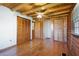 Bright bedroom with hardwood floors, wooden ceilings, ceiling fan, and closet space at 4801 Lynn Oaks Cir, Dover, FL 33527