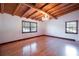 Bedroom with hardwood floors, chandelier, exposed beam ceiling, and natural light at 4801 Lynn Oaks Cir, Dover, FL 33527