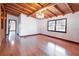 Bedroom featuring hardwood floors, chandelier, exposed beam ceiling, and natural light at 4801 Lynn Oaks Cir, Dover, FL 33527