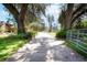 Long driveway leading to log home with well-manicured lawns and mature trees at 4801 Lynn Oaks Cir, Dover, FL 33527