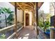 Welcoming entrance with a rustic wooden bridge, lush greenery, and stone accents at 4801 Lynn Oaks Cir, Dover, FL 33527