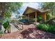 Charming log cabin home with inviting front porch and lush landscaping at 4801 Lynn Oaks Cir, Dover, FL 33527