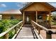 Charming log cabin with a wooden walkway leading to a welcoming front porch at 4801 Lynn Oaks Cir, Dover, FL 33527