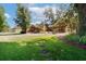 Landscaped front yard featuring a beautiful log home and a charming fountain at 4801 Lynn Oaks Cir, Dover, FL 33527