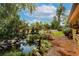Beautiful garden featuring a pond, mature trees, lush landscaping and relaxing ambiance at 4801 Lynn Oaks Cir, Dover, FL 33527