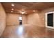 Spacious living room with wood paneled walls, laminate flooring, and ceiling fan at 4801 Lynn Oaks Cir, Dover, FL 33527