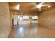 Open-concept living area with kitchen, wood paneled walls, and lots of light at 4801 Lynn Oaks Cir, Dover, FL 33527