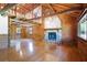 Expansive living room features a stone fireplace, wood walls, laminate flooring, and large windows at 4801 Lynn Oaks Cir, Dover, FL 33527